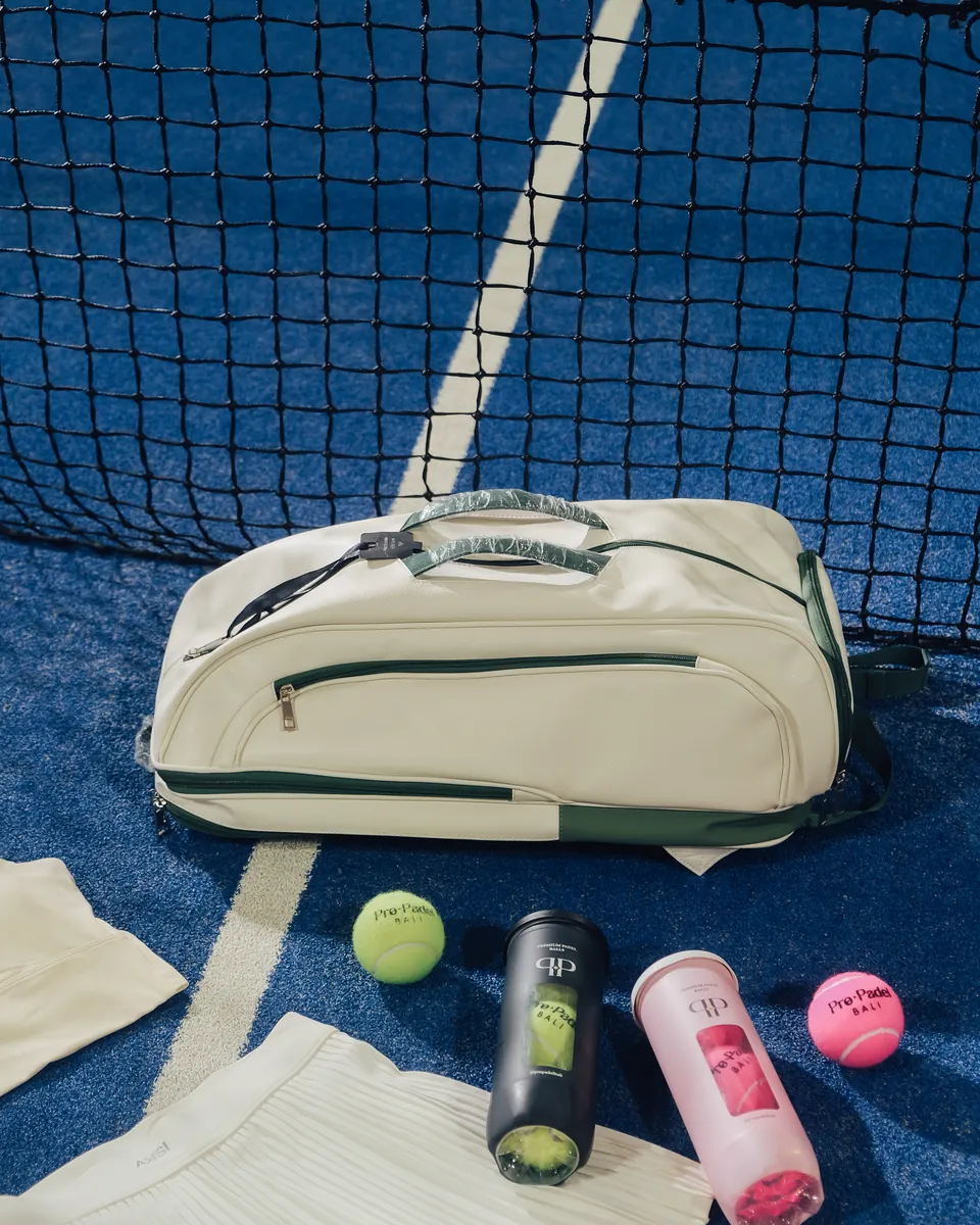 A padel bag and balls by the net