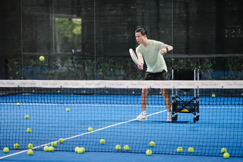 Coach Steven feeding balls on court