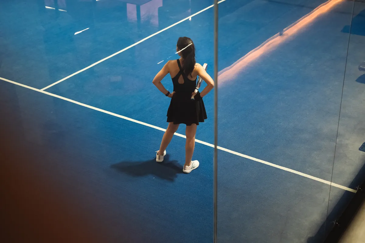 A player waiting for the serve on a blue court